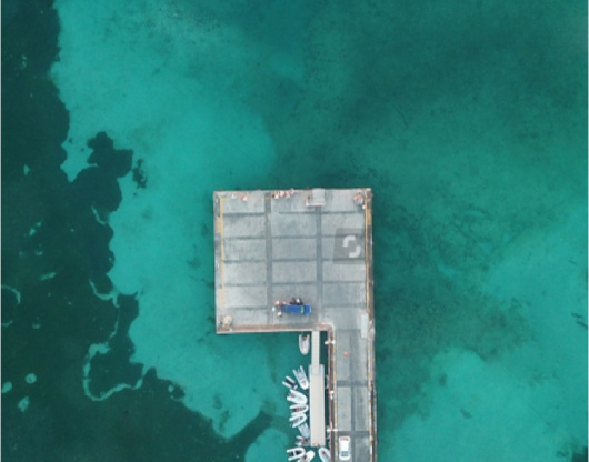 stock photo beautiful blue water with the pier of st louis in marie galante guadeloupe 1482480266 910x1155